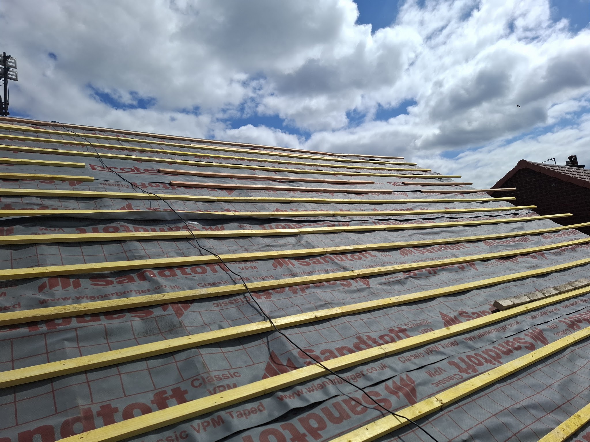 New roofing membrane and timber battens across a full roof slope
